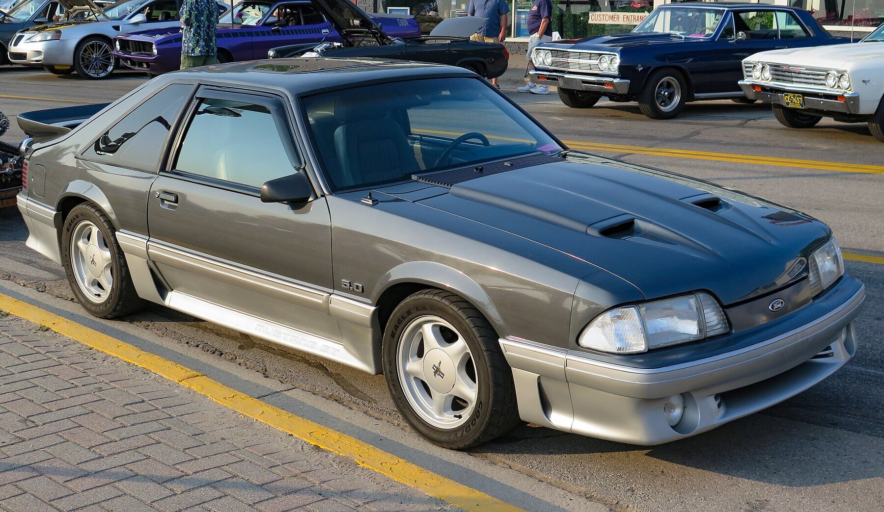 1987 Ford Mustang 2-Door Hatchback in Dark Grey Metallic, Front Right (St. Ignace 2023)