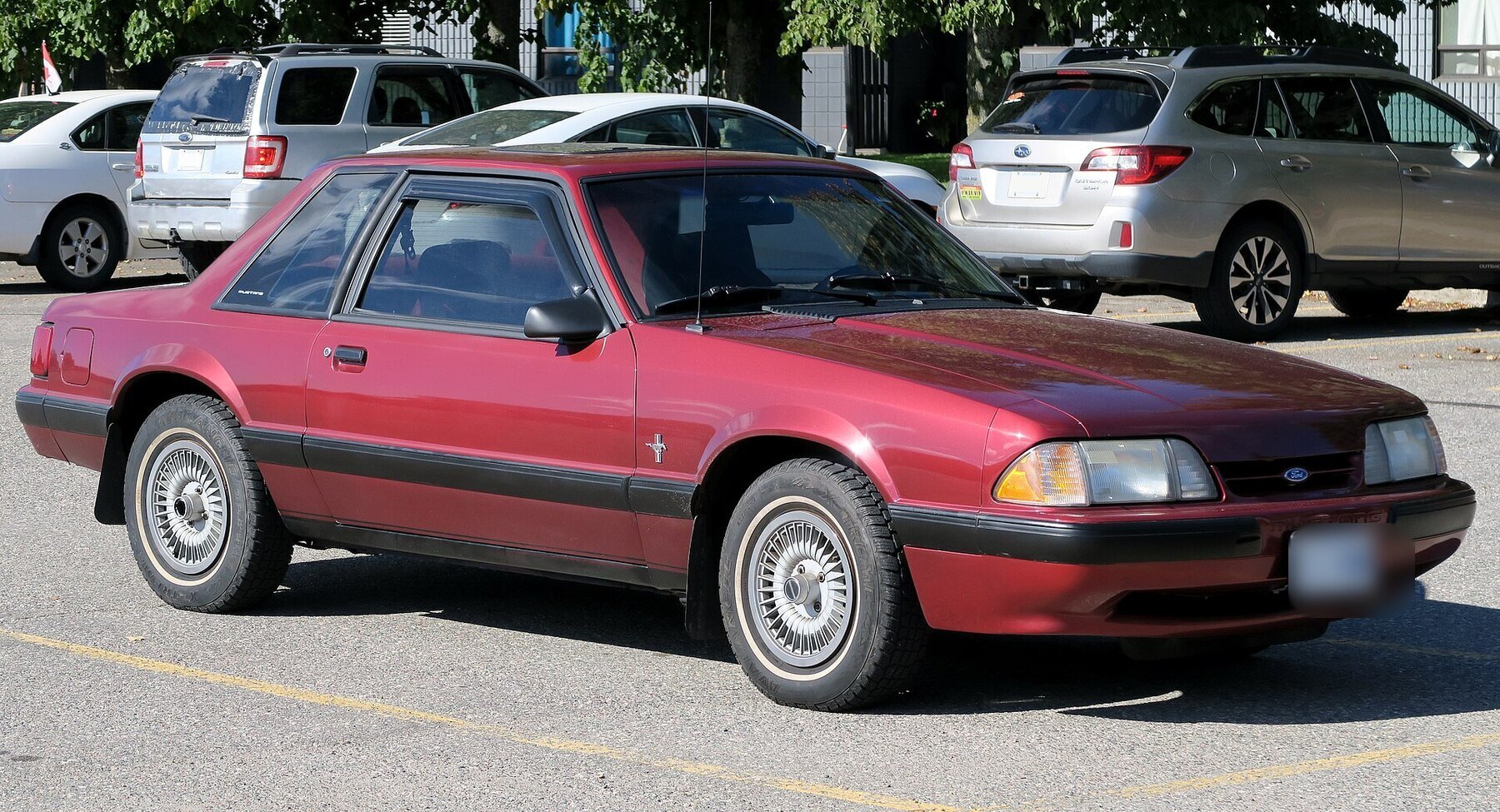1990 Ford Mustang LX 2-Door Sedan in Wild Strawberry, front right, 2024-10-07