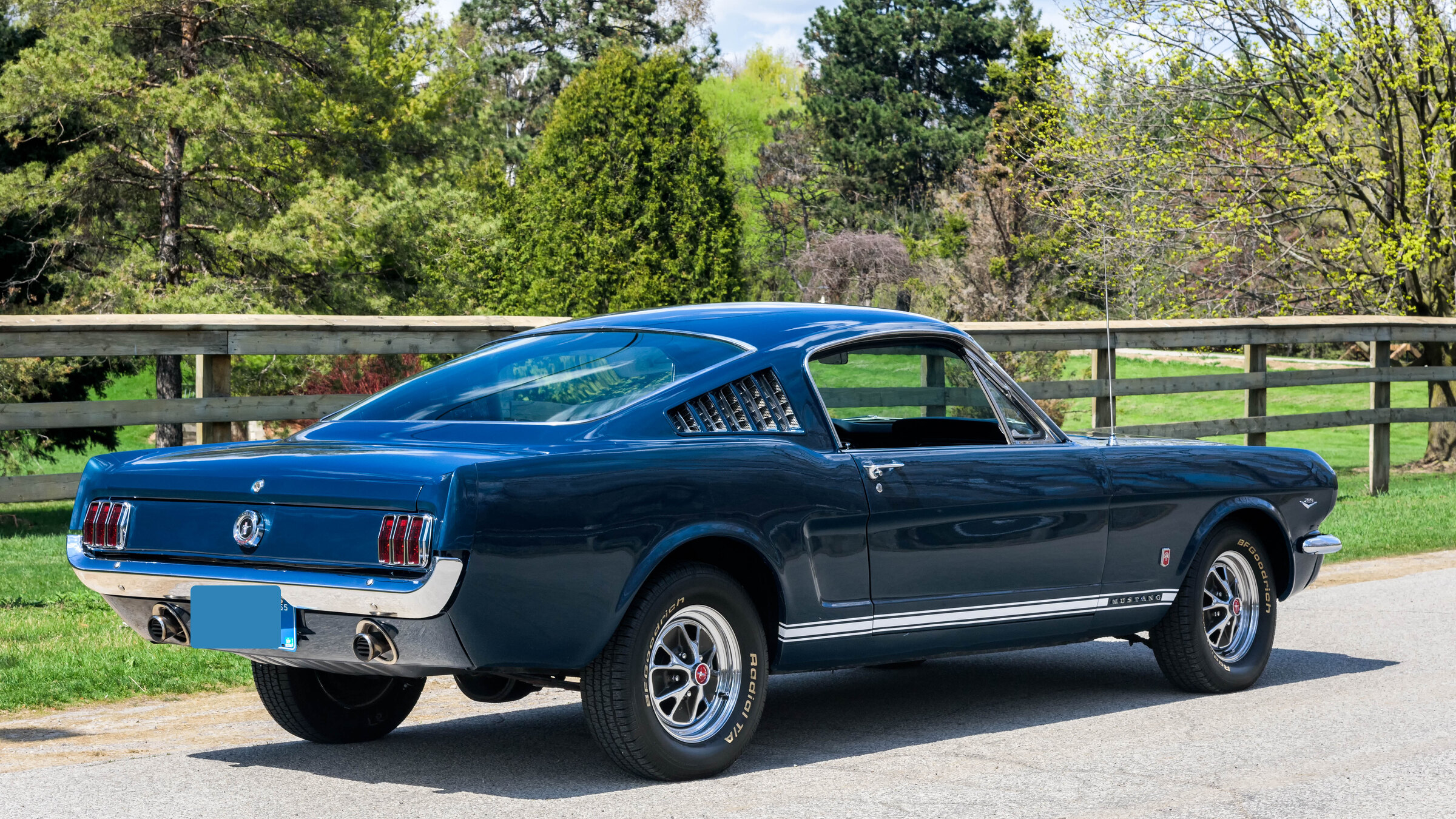 Blue 1965 Ford Mustang GT Fastback parked in profile